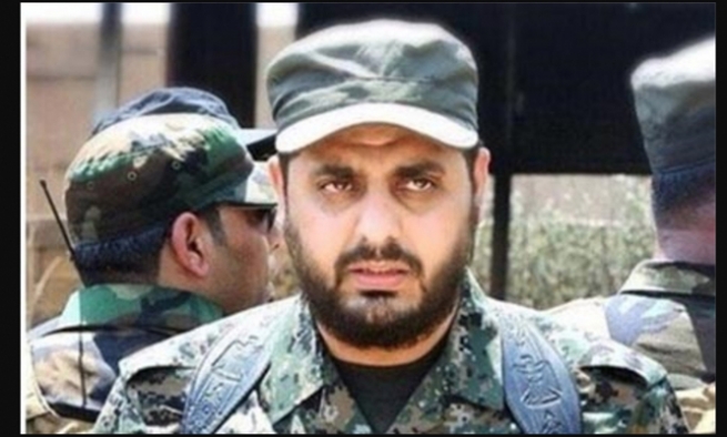 فەرماندەیەکی باڵای میلیشیاکانی حەشدی شەعبی سووکایەتی بە ئاڵای ئەمریکا دەکات